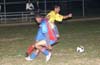 Gehider Garcia of Maidstone(yellow) getting by Hector Quintero of Bateman
