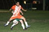 Alberto Larios of Tuxpan(front) holding the ball from Mark Christensen of Bayberry(rear)