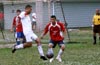 Carlos Torres of Bateman can not do much with the ball as Christian Munoz of Tortorella just watches