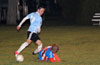 Afredo Negrete of The Hideaway sliding to steal the ball from Esteban Uchupaille of Bateman Painting
