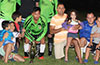 Second place winners Hampton FC, Oscar Reinoso(left), Carlos Torres, and Olger Araya, with kids