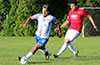 Oscar Reinoso of Hampton FC dribbling by Francisco Bonilla of Sag Harbor
