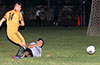 Donald Martinez of FC Tuxpan(left) getting rid of the ball before the slid tackle by Elvis Rojas of East Hampton
