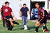Mark Bako of East Hampton(left) kicking the ball into a line of FC Tuxpan defenders