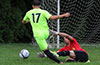 Jroge Lopez of Sag Harbor, sliding to block the shot by Nick Escalante of Maidstone Market