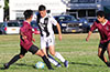 Donald Martinez of Sag Harbor(center) about to dribble past Robert Velez(left) and Gustavo Morastitla of East Hampton